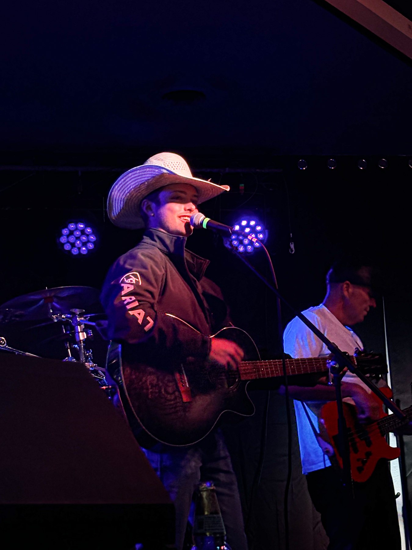 Jordan at the microphone with his guitar