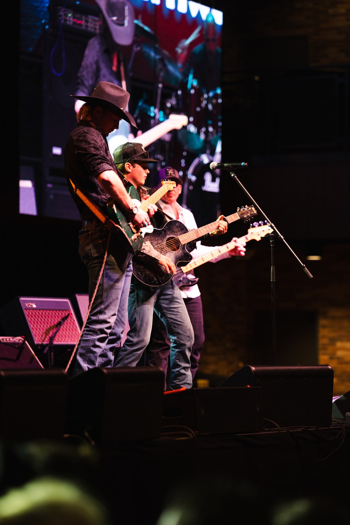 Jordan and the band performing under stage lights